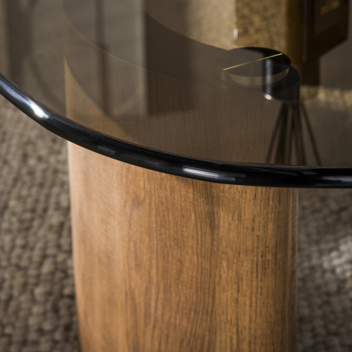Organic coffee table with smoked glass table top and oak wood-look legs detail