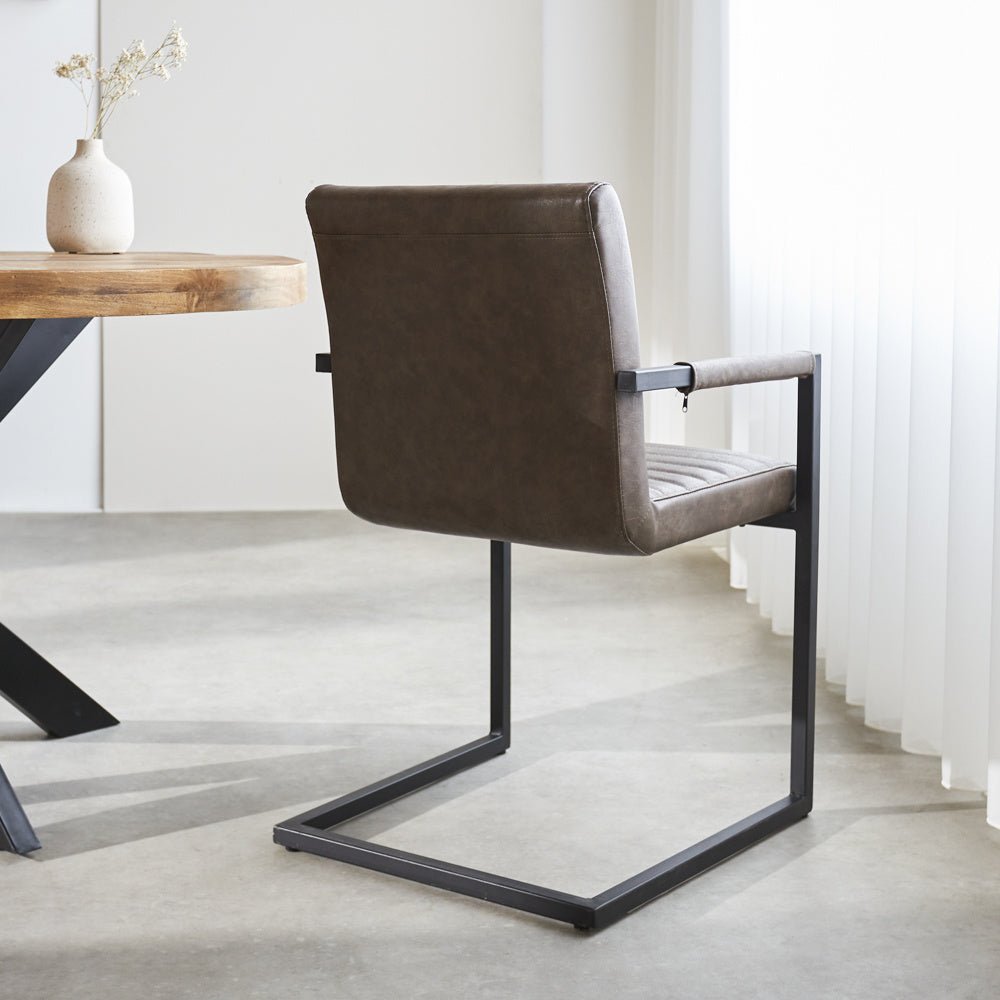 Dining room chair Kuba Dimehouse Taupe LxWxH 71x59x58 Faux leather Atmospheric photo diagonal rear view