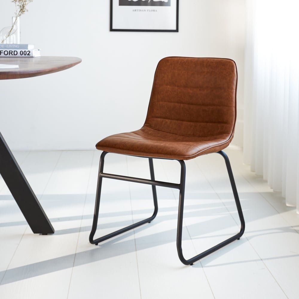 Dining room chair Mark Dimehouse Cognac LxWxH 74x56x54 Faux leather Atmospheric photo diagonal front view
