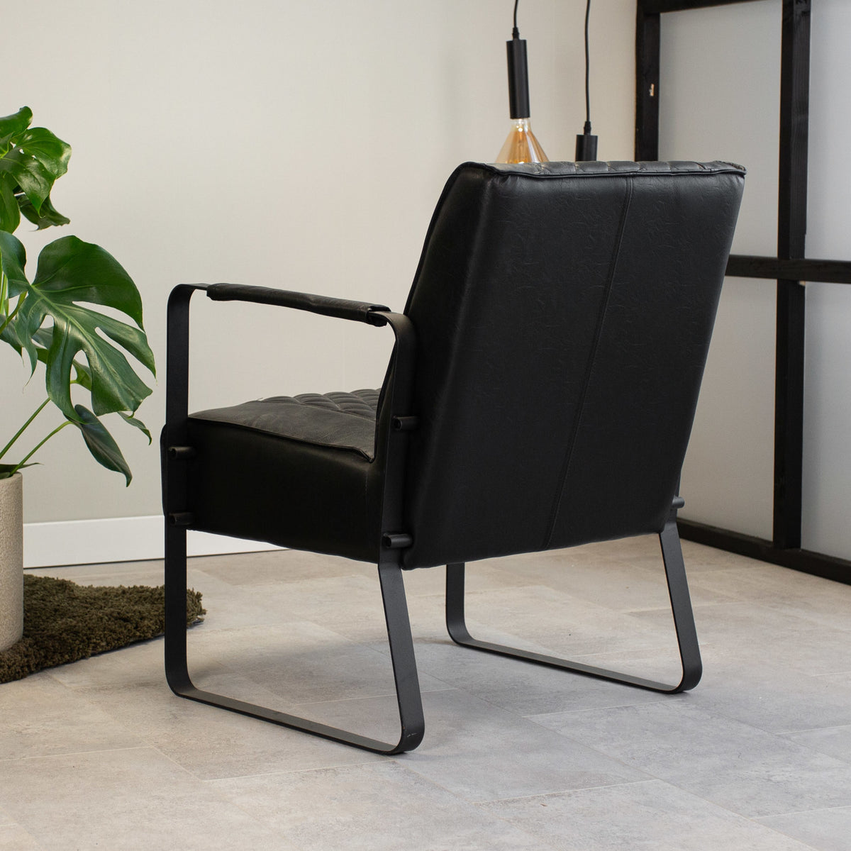 Armchair Peter Dimehouse Black LxWxH 68x63x45 Faux leather Atmospheric photo diagonal rear view
